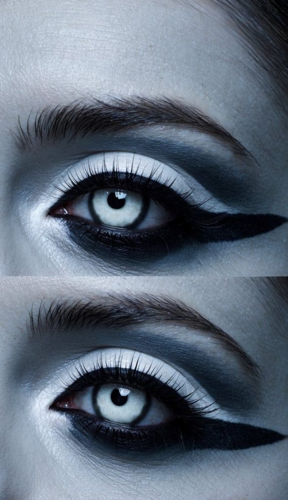 This haunting look features grayscale face makeup with dramatic black winged accents, perfectly paired with eerie white lenses. 