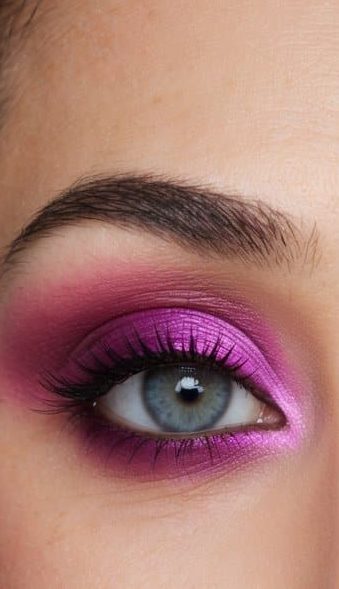 A pair of eyes with a sophisticated and long-lasting purple and pink gradient eye makeup look