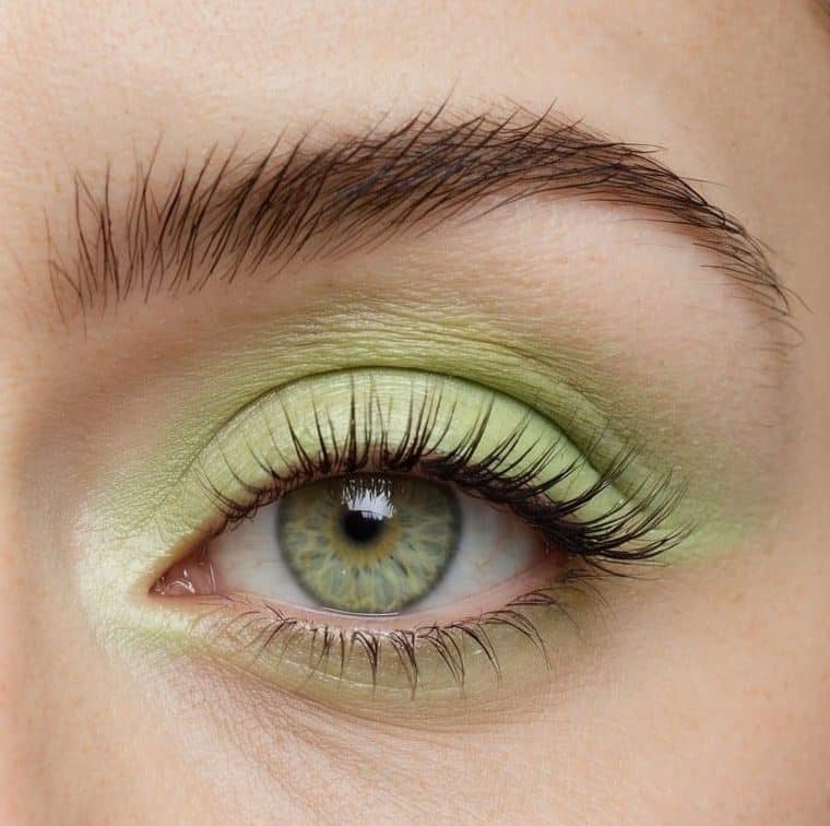 A close-up of a pastel green eye with a splash of lime sorbet-inspired eyeshadow, creating a soft and refreshing look