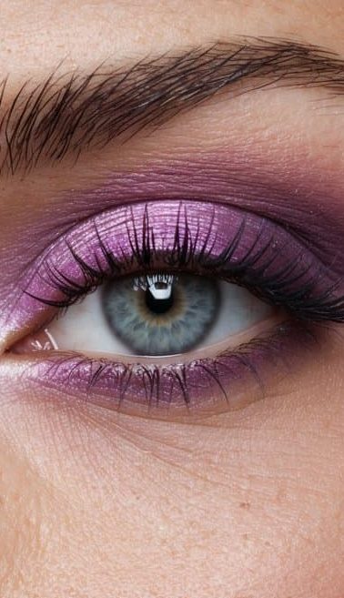 A close-up of a pink and violet eyeshadow palette with a soft, smoky effect