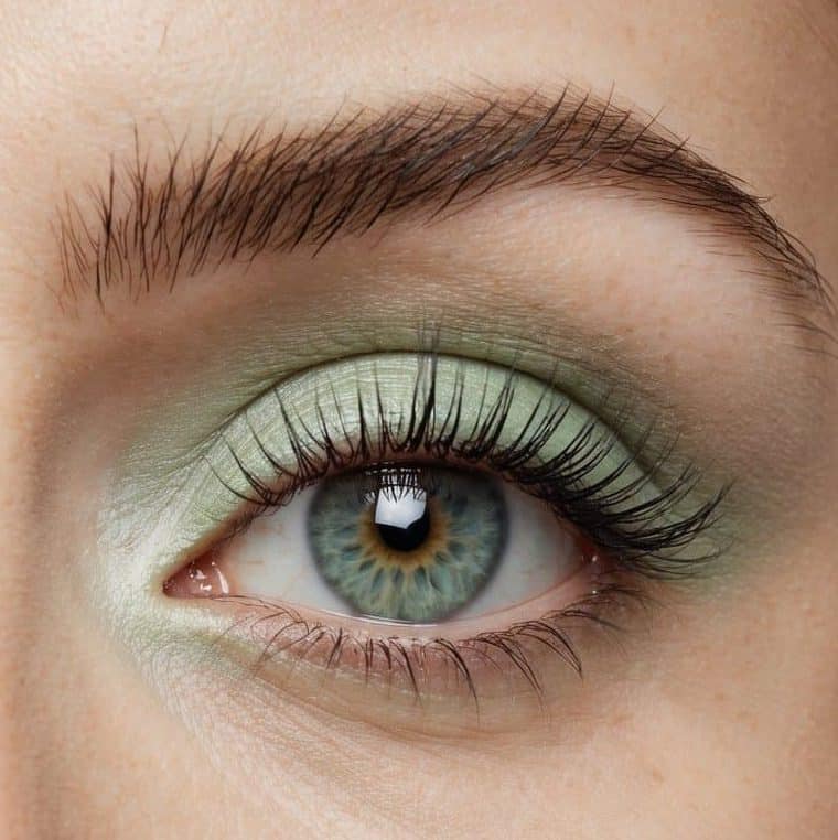 A close-up of a pastel green eye with a soft and refreshing makeup look