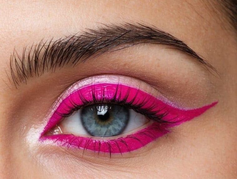 A close-up of fuchsia and pink eyeliner stacked on the upper eyelid, creating a trendy and vibrant eye makeup look