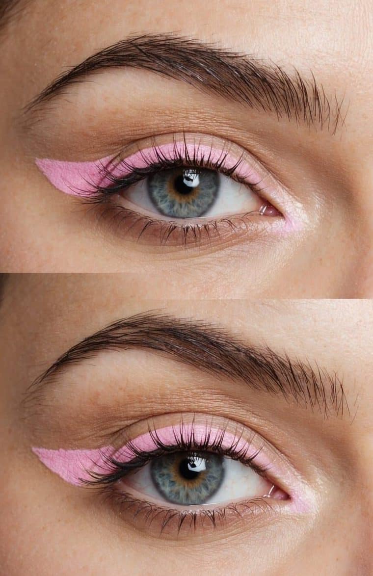 A close-up of a pair of eyes with pastel pink eyeliner, creating a trendy and bold makeup look