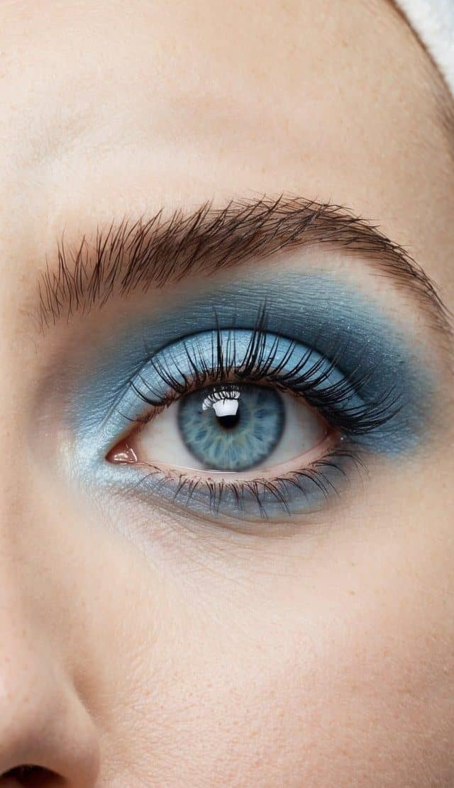 Soft and dreamy sky-blue eye makeup on a clean, uncluttered surface with soft lighting