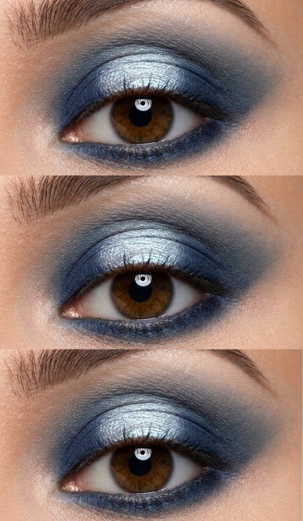 Halo eye makeup style showcasing a glowing silver center lid surrounded by smoky navy blue blending along the crease and lash lines.