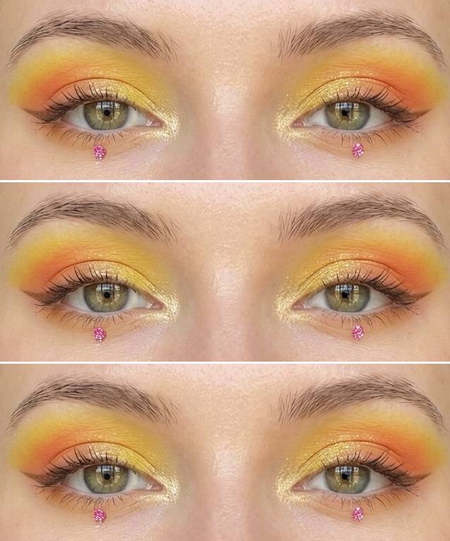Haldi eye makeup look featuring a yellow and orange gradient blend, soft gold shimmer at the tear duct, and a pink rhinestone placed just below the lower lash line.