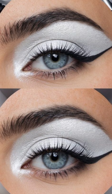 A close-up of a silvery white eye makeup look, with a pop of color, surrounded by various eye makeup products and tools