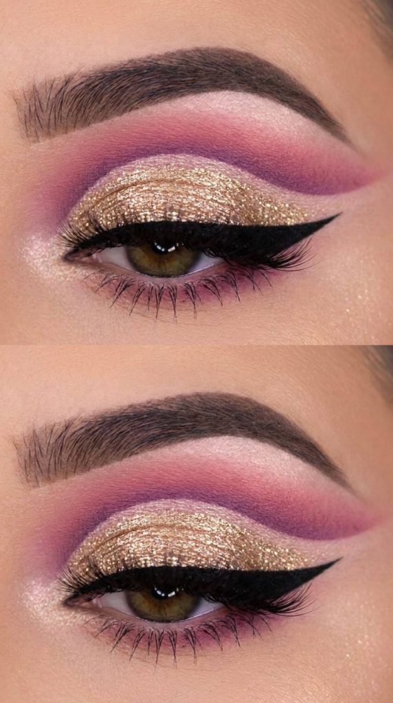 A full cut crease eye makeup idea combining foiled gold glitter lids with magenta-lavender transitions and precise black wing liner.
