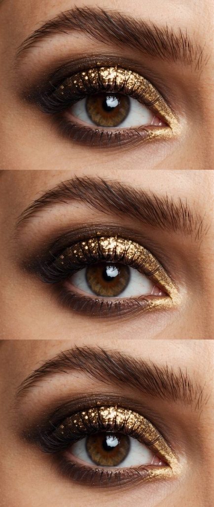 Gold shimmer and glitter on a dark smokey base, offering a glamorous and striking eye makeup idea for brown eyes.