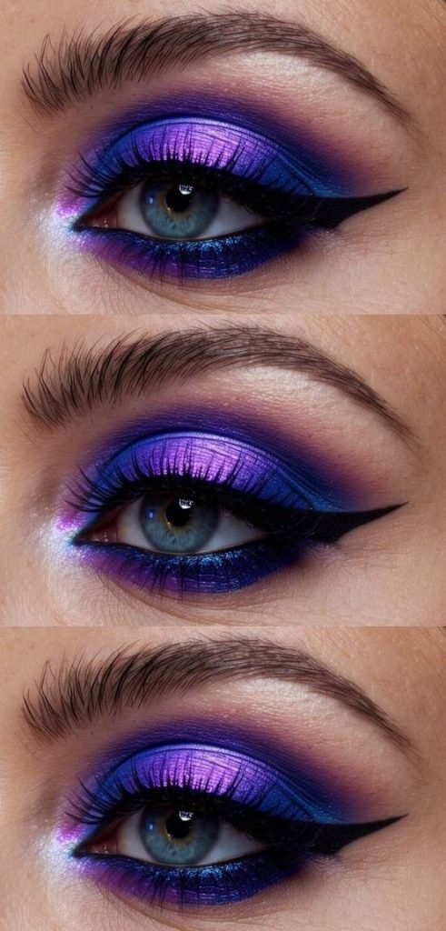 Neon eye makeup idea using reflective purple shadow over navy smokey edges and a bold eyeliner wing for a dramatic, theatrical effect.