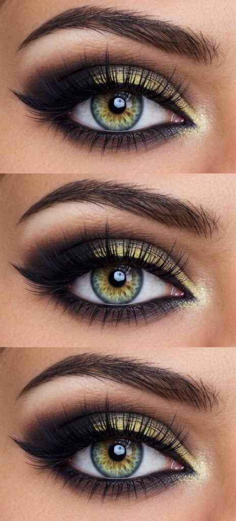 Simple Halloween eye makeup idea with vibrant yellow shimmer on the eyelid and dramatic black smoke blended outward for a bold, striking look.