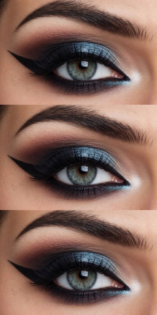 A close-up of an eye with dramatic makeup, featuring dark winged eyeliner, metallic blue eyeshadow, and thick, defined eyebrows.
