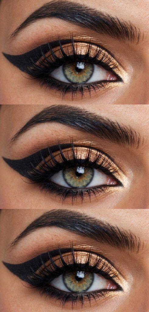 Arabic eye makeup idea inspired by regal tones, showcasing high-shine gold shadow and deep black liner sweeping into a bold, elongated wing.
