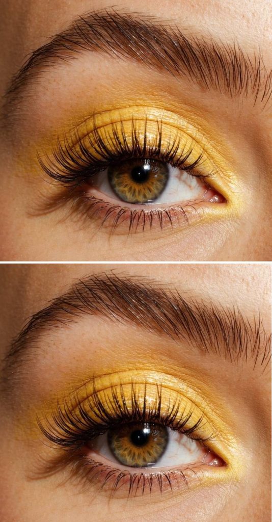 Close-up of metallic marigold shimmer on eyelids, illustrating radiant yellow eye makeup ideas paired with long, defined lashes.