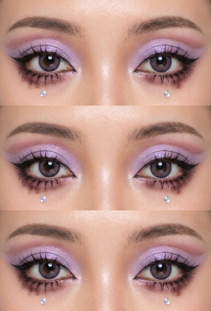 Gyaru eye makeup with pastel lilac eyeshadow, diffused mauve shadow under the eyes, and rhinestones placed strategically for a sparkly accent.