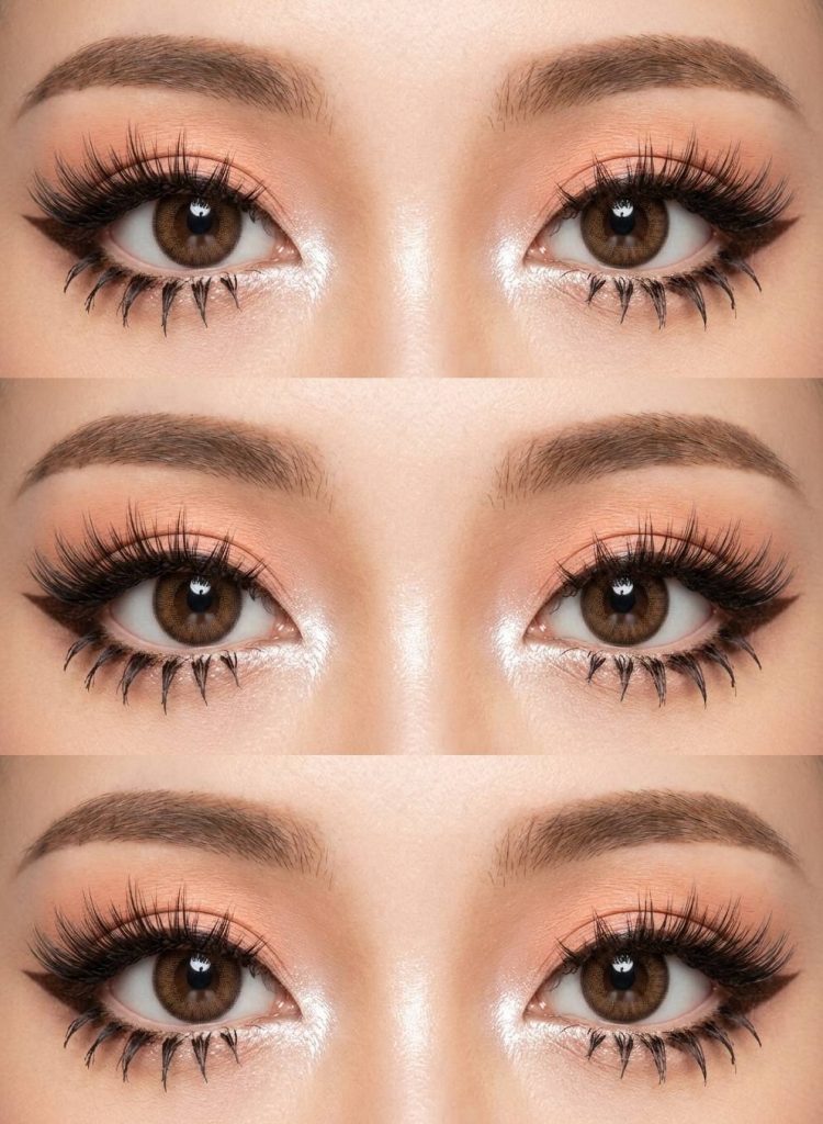 Gyaru eye makeup look with peach shimmer lids, strong white inner corners, thick upper lashes, and pointed black lower lashes for a wide-eyed effect.