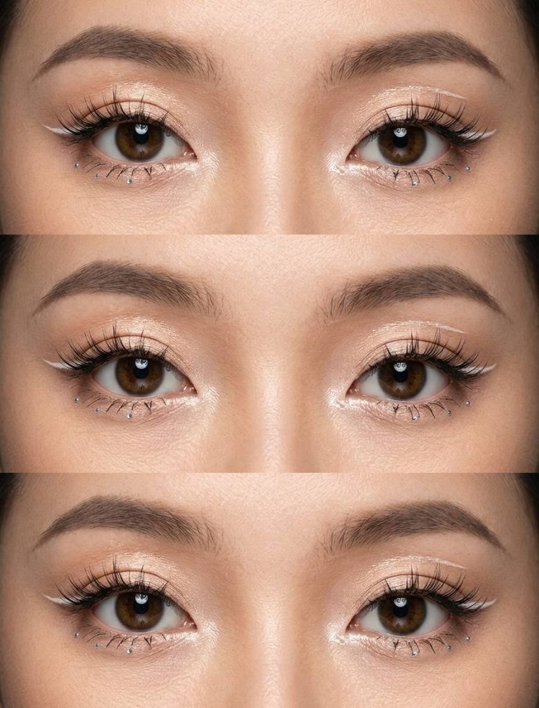 Close-up of douyin eye makeup trend with white eyeliner, tiny silver rhinestones under the eyes, and champagne shimmer across the eyelids and inner corners.