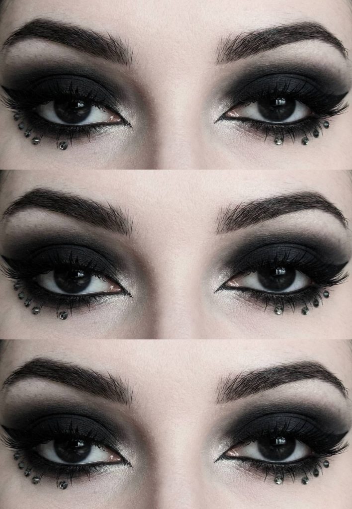 A trad goth eye makeup look featuring intense black shadow, seamless blending, and metallic studs placed along the lower lash line for a spiked effect.