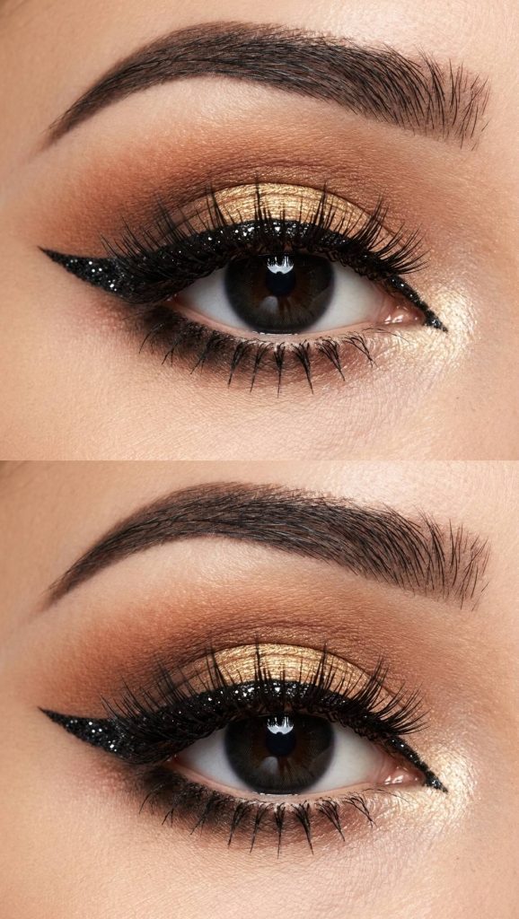 Gyaru eye makeup look featuring gold shimmer on the lid, black glitter eyeliner with a winged flick, and brown blended shadow in the crease.