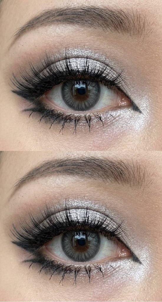 An ethereal gyaru eye makeup look showcasing silver shimmer lids, thick lashes, and a clean black eyeliner wing, like moonlight over water.