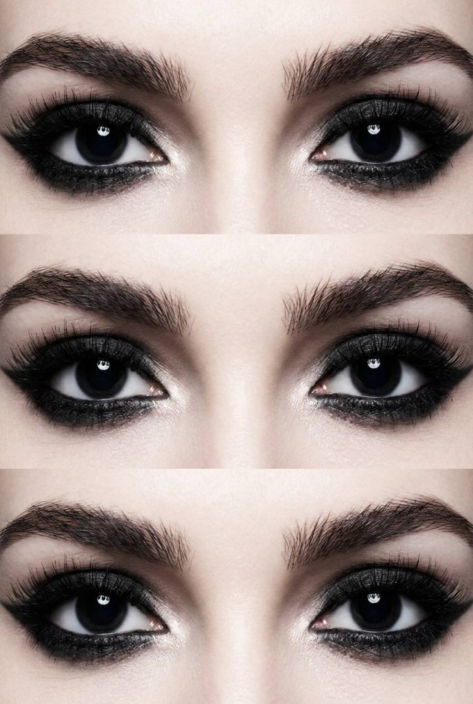 Smokey trad goth eye makeup look with black eyeshadow encircling the whole eye and diffused for a dramatic, high-contrast effect.