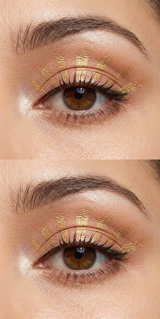 Crazy eye makeup looks featuring bold gold brush strokes above the lashes, styled like sun rays against a neutral lid.