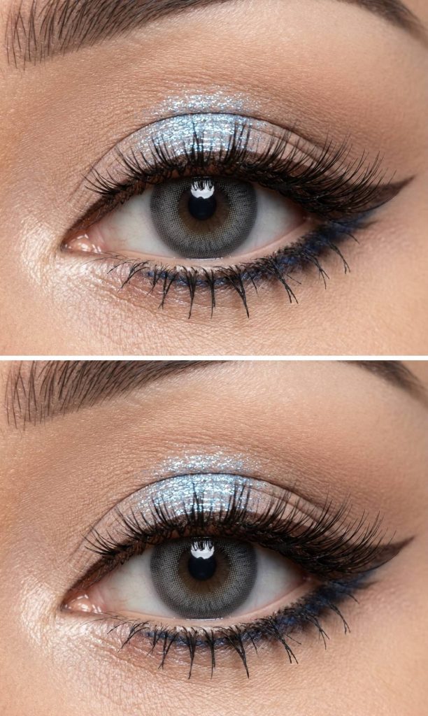 Close-up of gyaru makeup with blue glittery eyeshadow on the eyelids, soft nude crease blending, and fluttery lashes for a playful, eye-brightening effect.