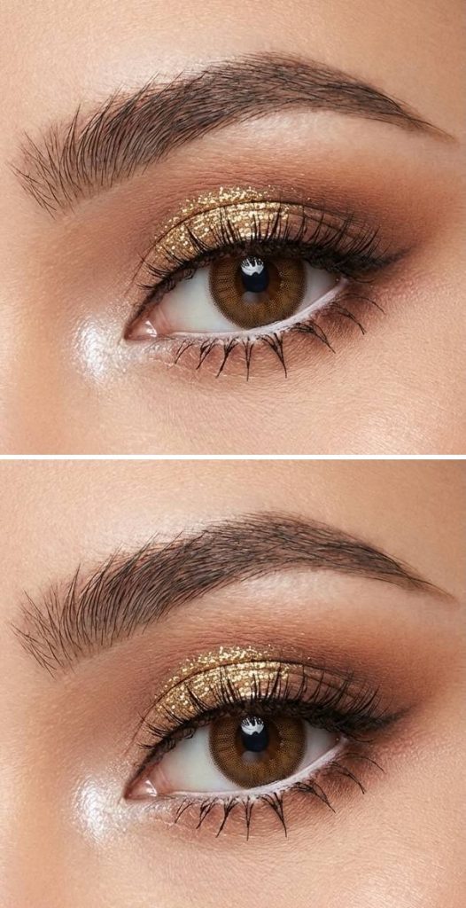 Eye makeup with shimmering gold glitter across the lid and soft brown shadow for contour, inspired by anime eye aesthetics.