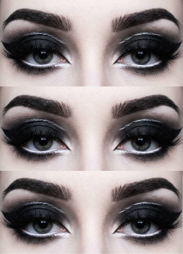 Eyes with a dramatic trad goth makeup style featuring intense black eyeshadow, glossy lashes, and a metallic silver crease cutting across the lid.