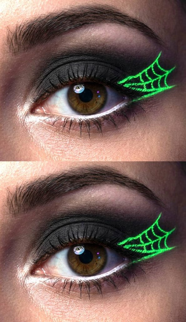 Close-up of an eye with black eyeshadow and glow-in-the-dark green spiderweb eyeliner extending from the outer corner of the eye.