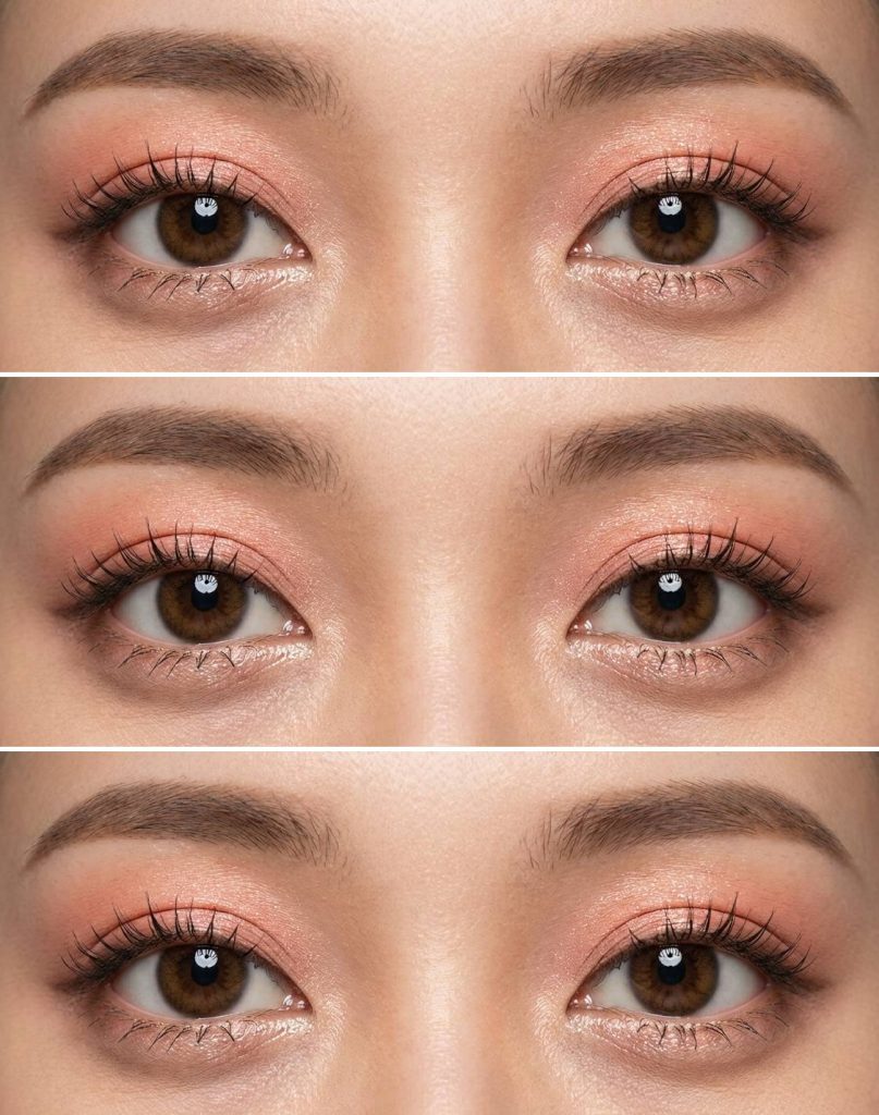 Warm-toned douyin eye makeup trend with coral-pink shadow, slightly glossy finish on the eyelids, and softly curled lashes for an innocent, dewy effect.