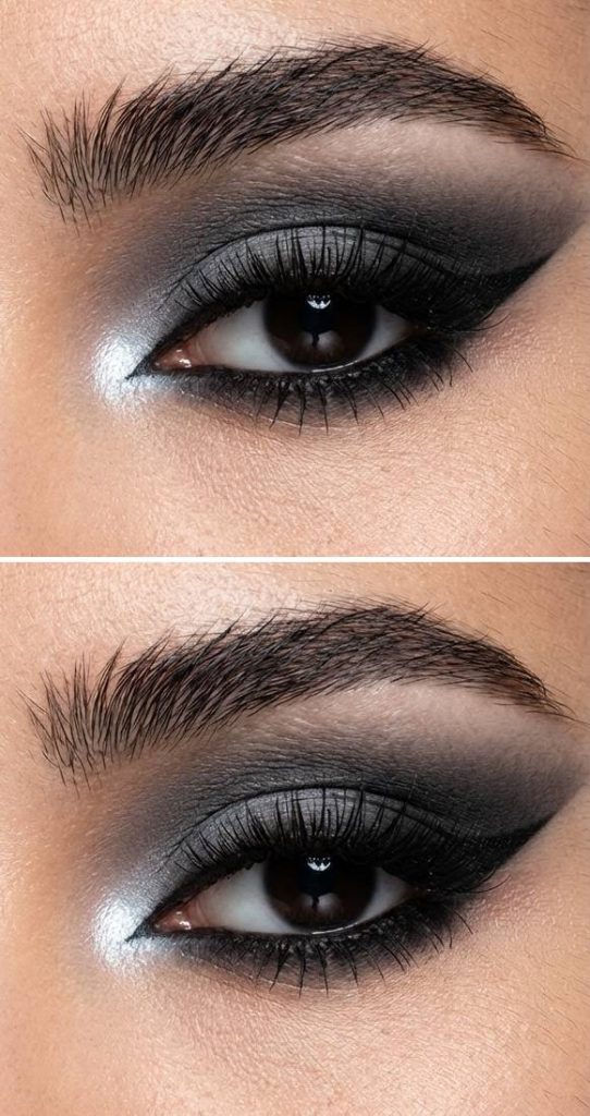 An eye showcasing a trad goth eye makeup look with blended graphite eyeshadow and shimmering silver at the inner corner for a halo-inspired finish.