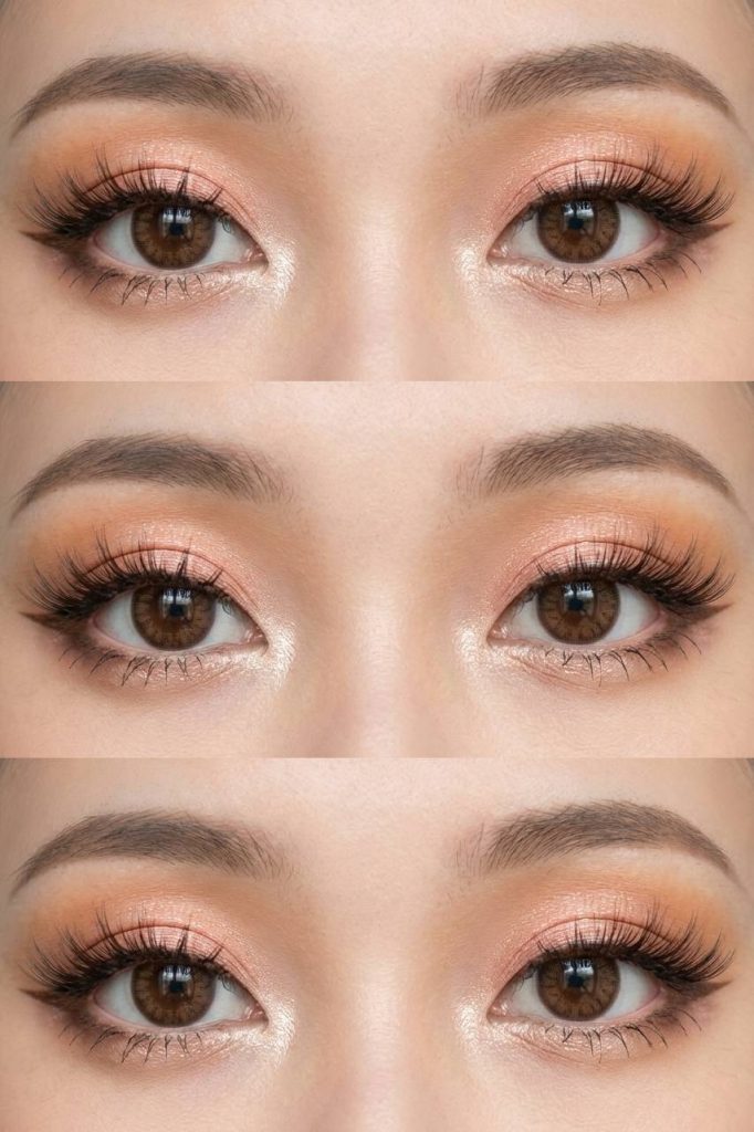 A peach-toned gyaru eye makeup look with soft shimmer on the lids, defined lashes, and a gentle highlight on the inner corners.