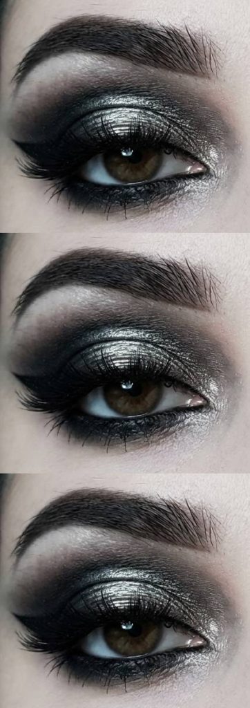 Intense smokey trad goth makeup look featuring a bold silver shimmer on the lid, black shadow smoked upward, and thick black lashes.