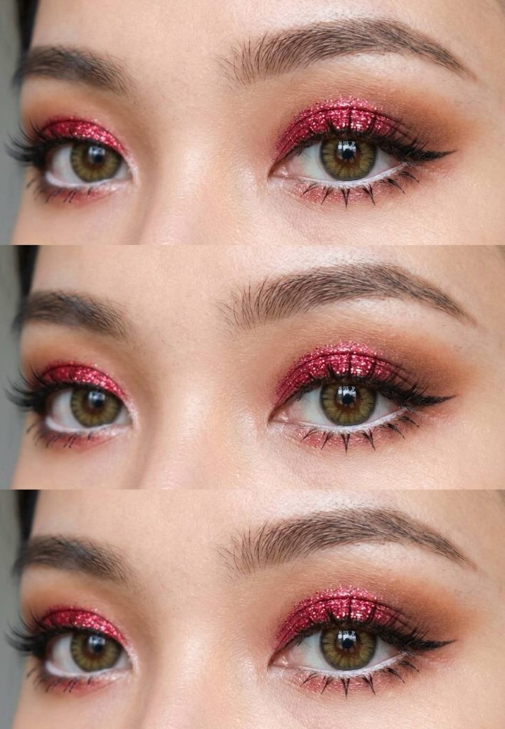 Close-up of an anime eye makeup look featuring bold ruby red glitter on the eyelids with softly blended warm brown shadow on the outer V.