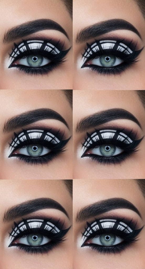 A spiderweb eye makeup idea with crisp white eyeshadow and black liner forming a stylized web across the upper lid, framed by dramatic lashes and sharp angles.