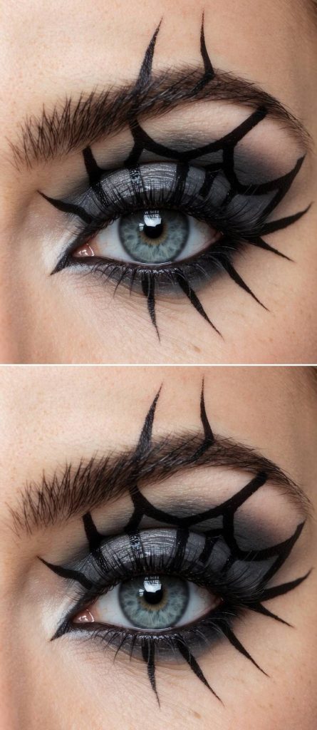 Close-up of a spiderweb eye makeup idea where claw-shaped black liner forms an angular web over dark gray eyeshadow and bold lashes.