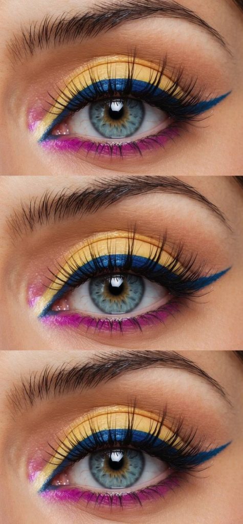 Vivid gyaru eye makeup look with golden yellow eyeshadow, dramatic cobalt blue winged eyeliner, and fuchsia tones lining the lower lashes.