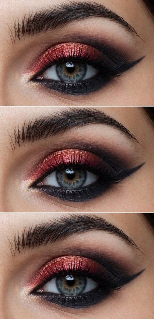 Close-up of a trad goth eye makeup look with ember-toned shimmer on the lid, smoked edges, and winged eyeliner.