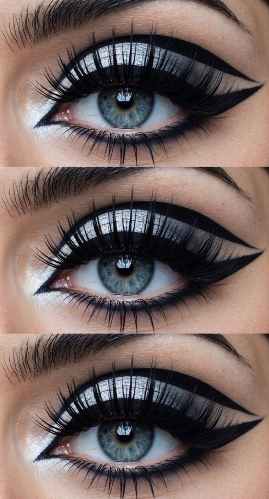 Trad goth eye makeup look showcasing chrome silver eyelids with wide black liner bands and defined winged eyeliner above and below the lash line.