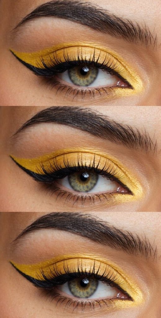 Haldi eye makeup look with vivid yellow shimmer on lids and precise black eyeliner shaped into a bold flick.